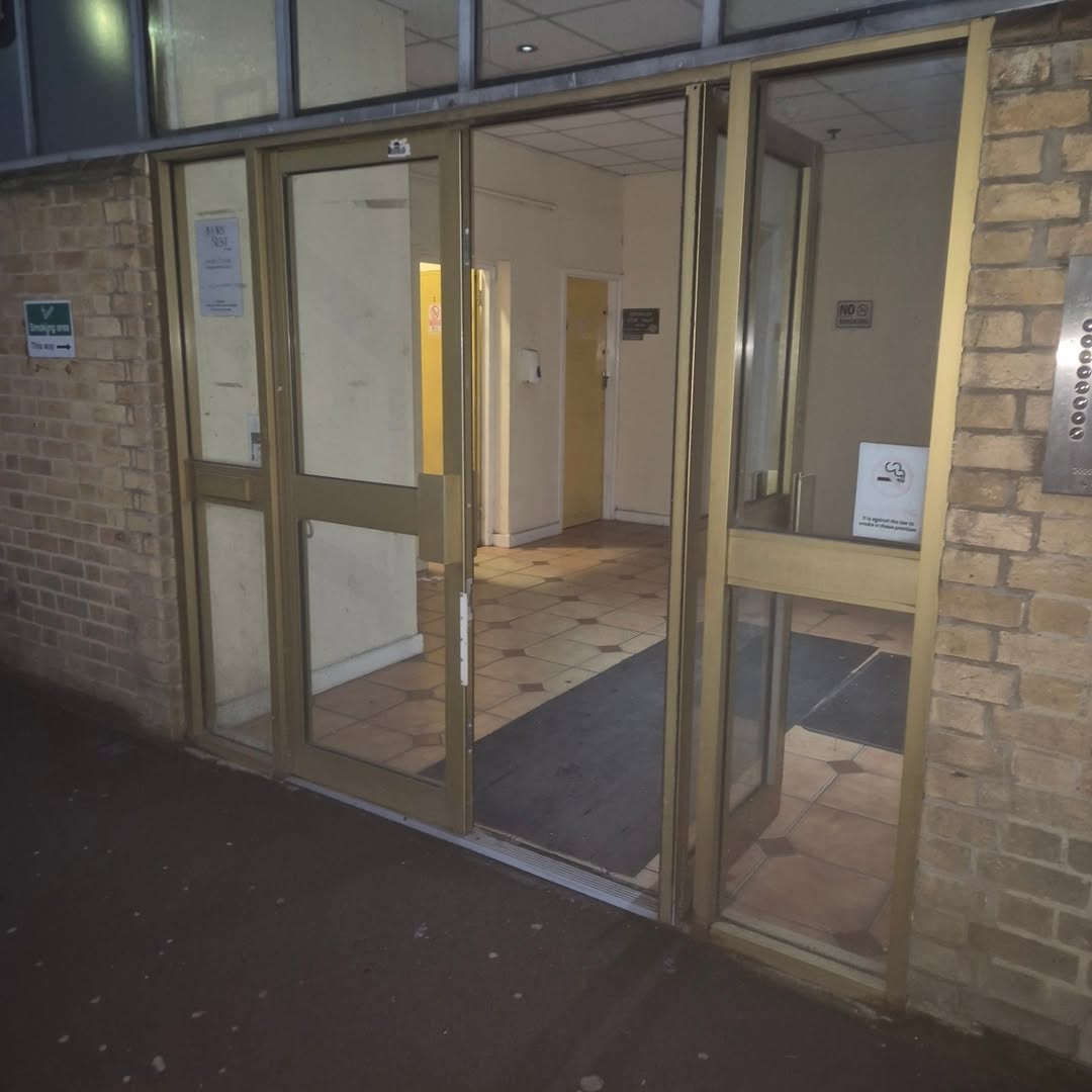 Gold-framed glass double doors at the Kapital Building main entrance