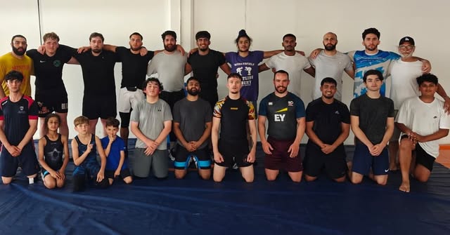 Full Leicester Freestyle Wrestling squad, juniors and seniors, on blue mats