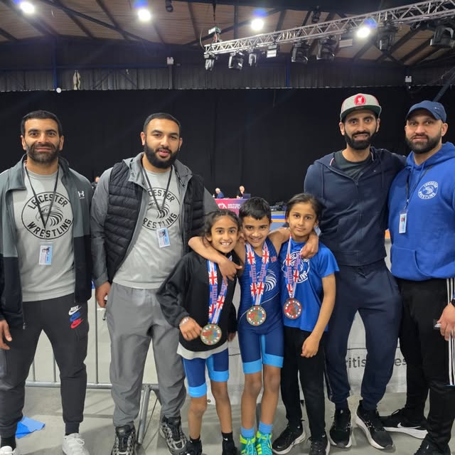 Coaches and junior medallists at a British Wrestling competition